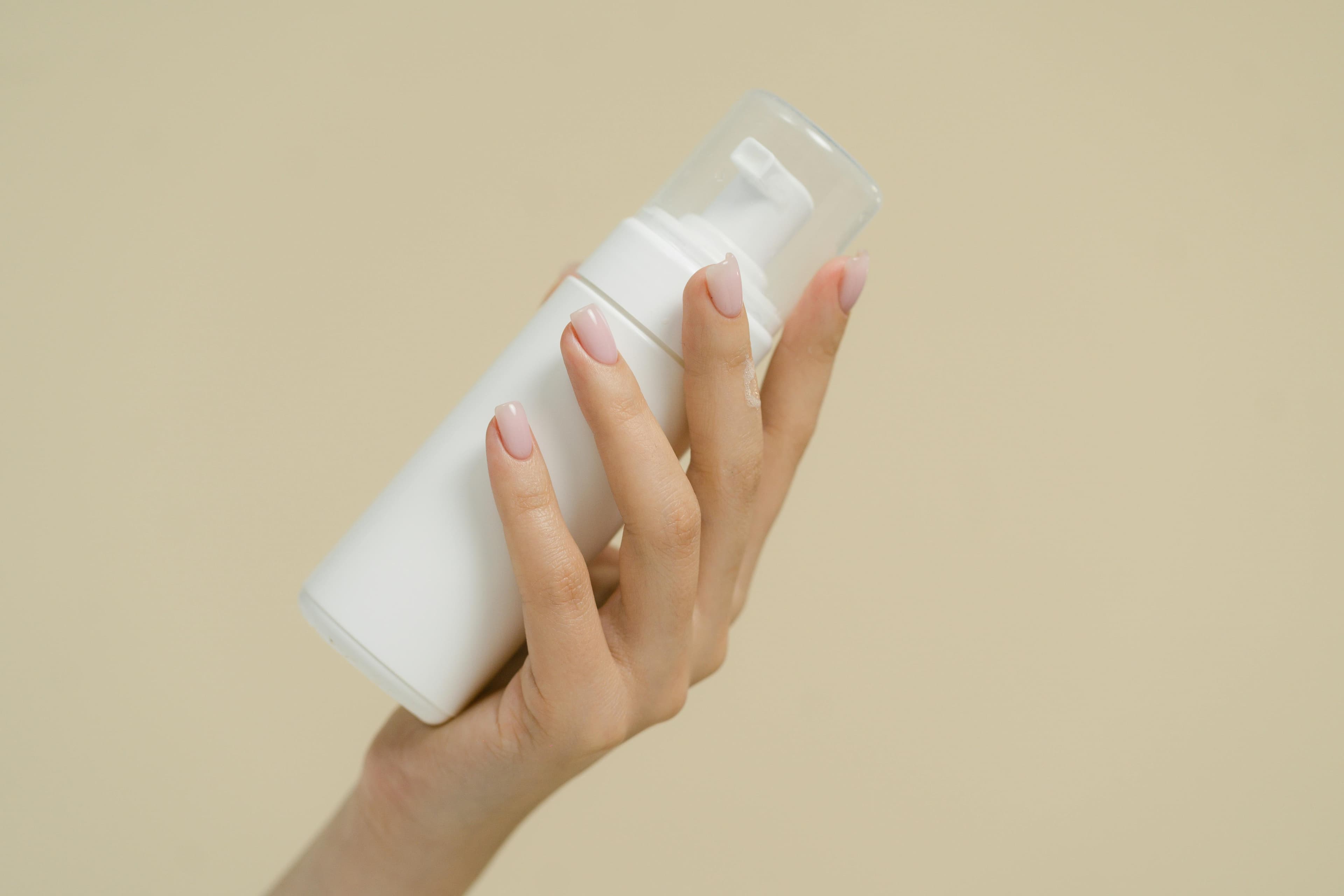 Hand holding a compounded topical bottle
